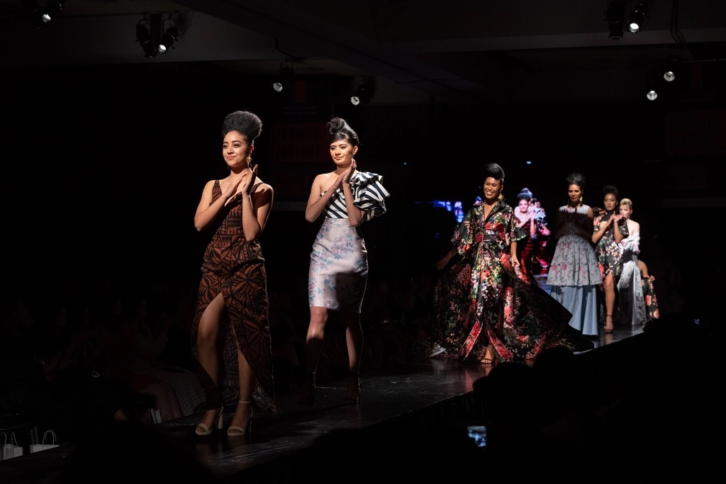 Models walking the finale of a contemporary runway show
