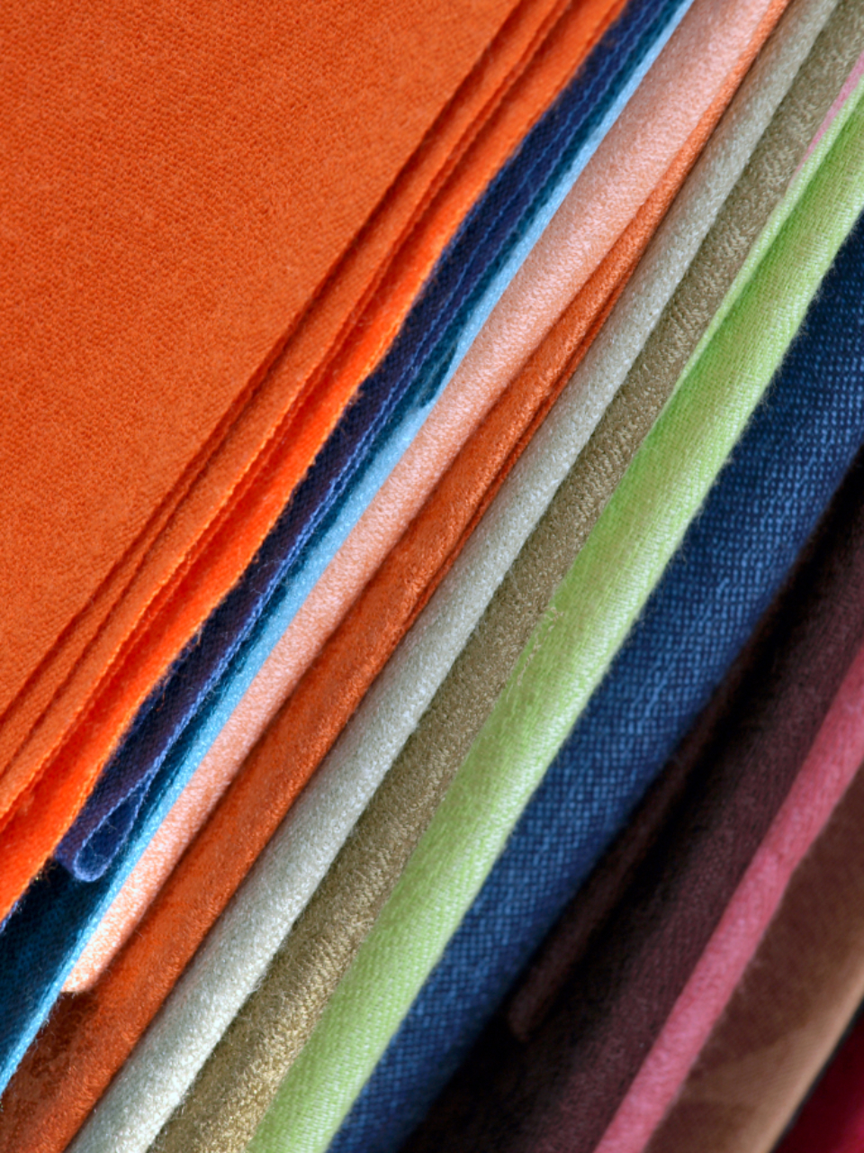 Folded fabrics stacked by colour