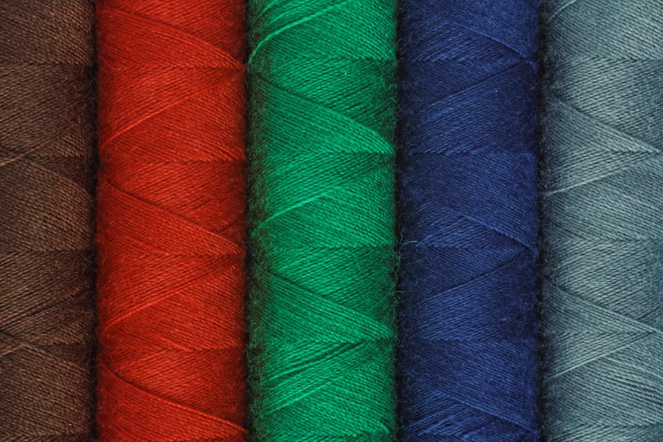 Colourful thread spools on a work table